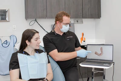 doctor showing patient how dental implants work
