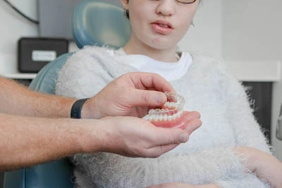 doctor showing patient how Invisalign clear aligners work