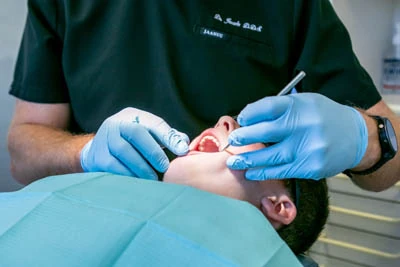 patient in dental chair receiving oral surgery